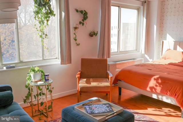 bedroom with wood finished floors and baseboards