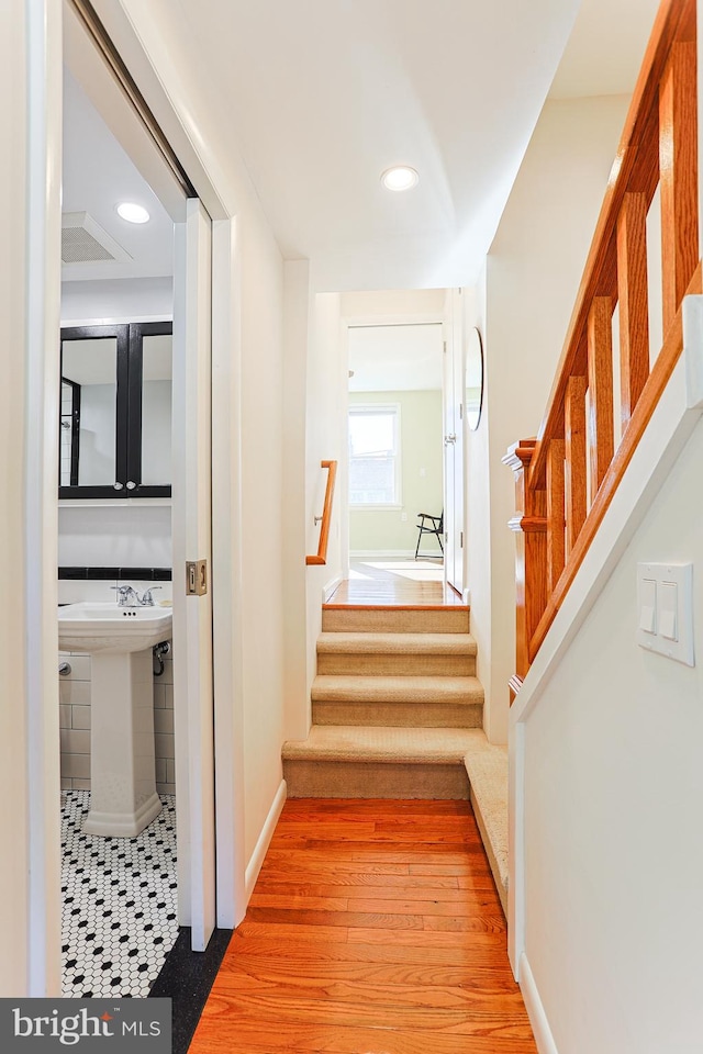 hall featuring sink and light hardwood / wood-style floors