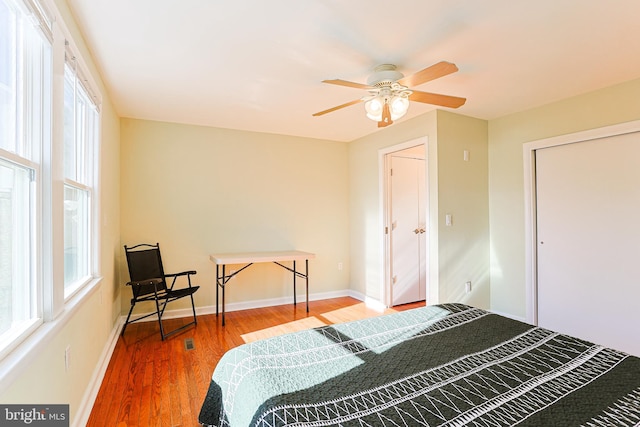 bedroom featuring a closet, hardwood / wood-style flooring, and ceiling fan