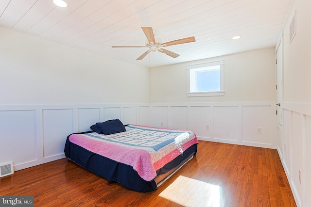 bedroom with ceiling fan and hardwood / wood-style flooring