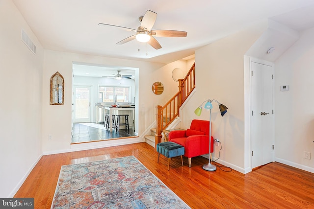 sitting room featuring ceiling fan and hardwood / wood-style flooring