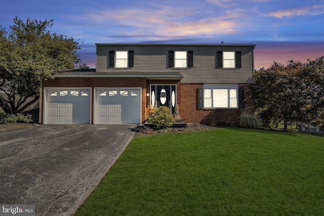 view of property with a lawn and a garage