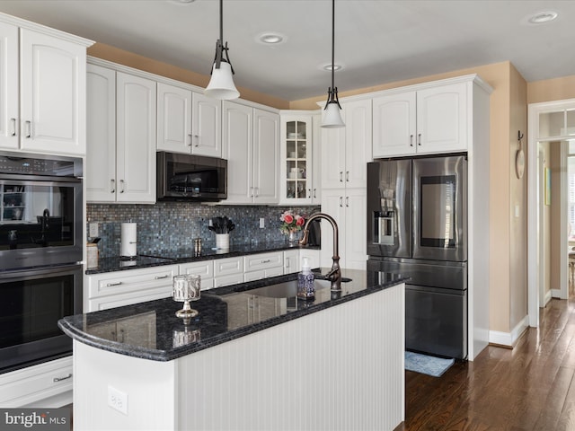 kitchen featuring white cabinets, hanging light fixtures, dark hardwood / wood-style floors, sink, and stainless steel appliances