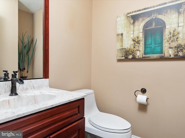 bathroom with toilet and vanity