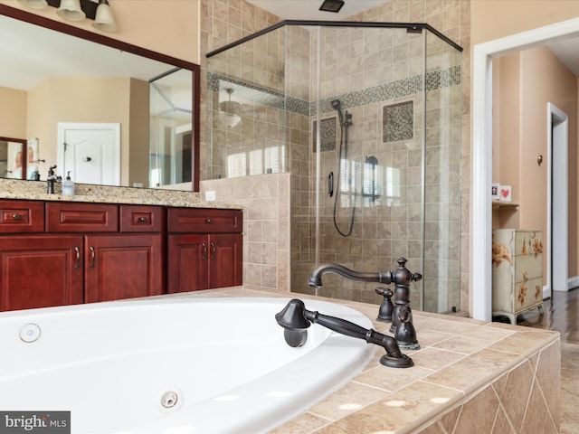 bathroom with vanity and separate shower and tub