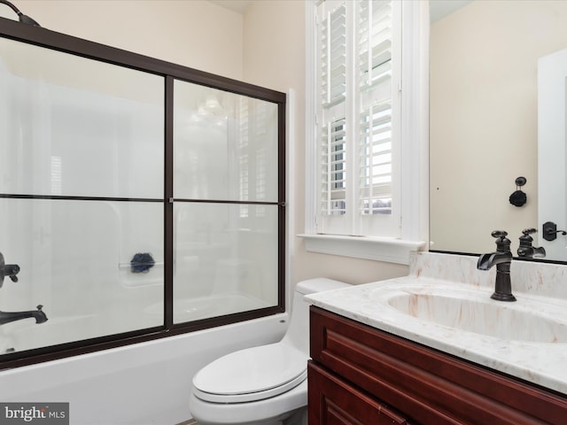 full bathroom with vanity, toilet, and shower / bath combination with glass door