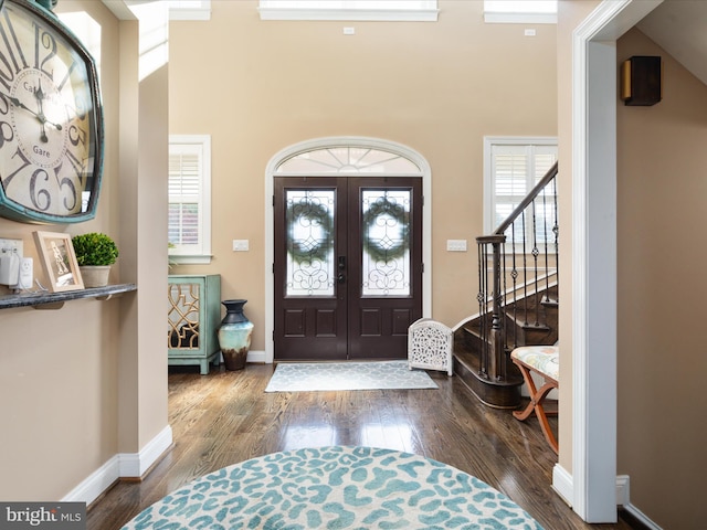 foyer featuring french doors, high vaulted ceiling, and dark hardwood / wood-style flooring