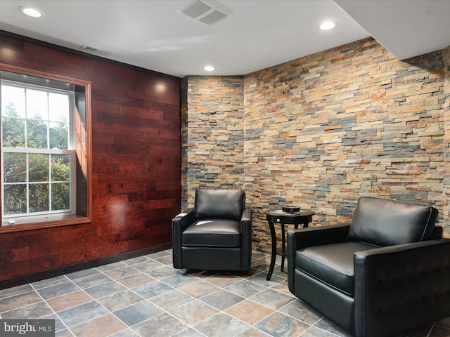 sitting room featuring wooden walls