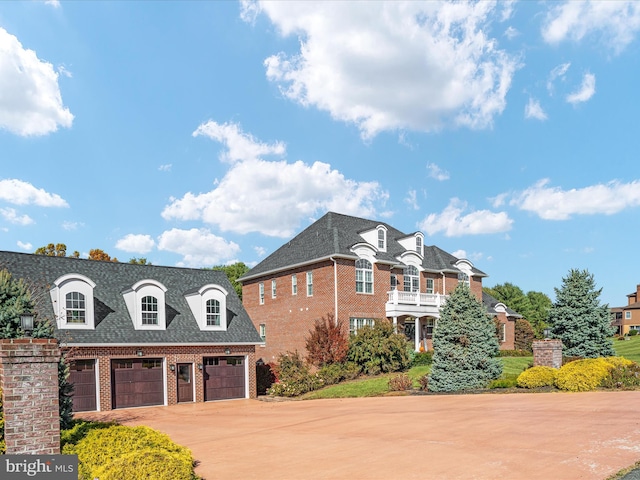 view of front of property with a balcony and a garage