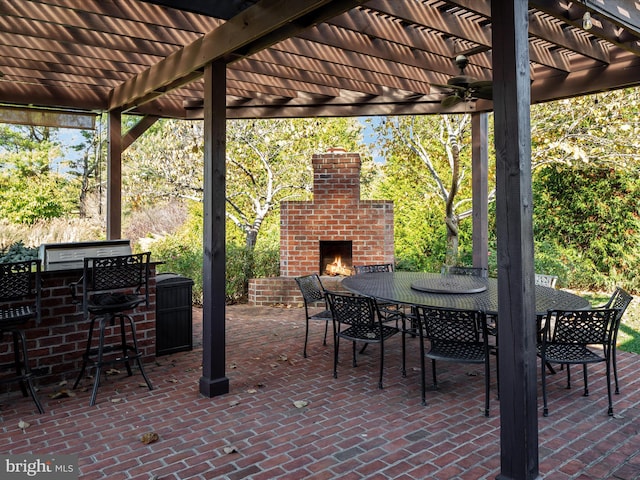 view of patio / terrace with ceiling fan, an outdoor brick fireplace, and a pergola