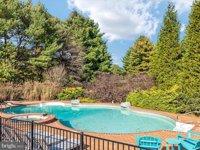 view of pool with a jacuzzi and a diving board