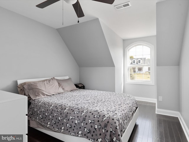 bedroom featuring dark wood-type flooring, ceiling fan, and vaulted ceiling