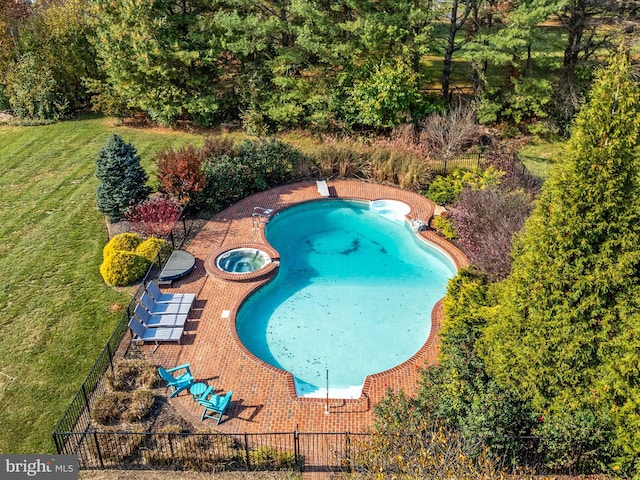 view of pool with a patio, an in ground hot tub, a diving board, and a lawn