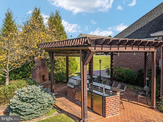 view of patio / terrace featuring exterior kitchen and a pergola