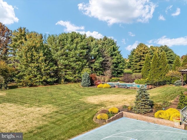 view of yard with basketball court