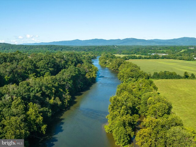 birds eye view of property with a water and mountain view