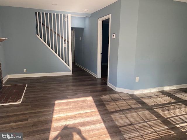 empty room featuring dark wood-type flooring