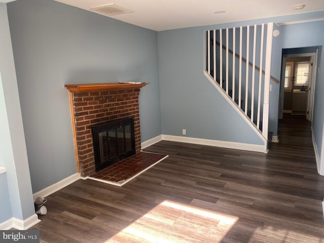 unfurnished living room with dark hardwood / wood-style floors and a fireplace