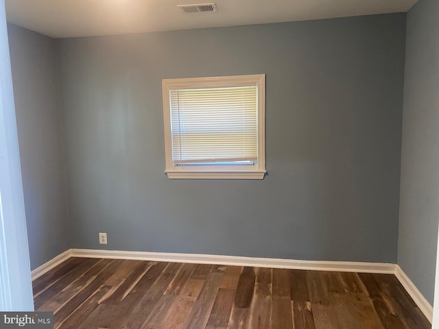 spare room with dark hardwood / wood-style floors