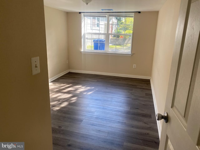 spare room featuring dark hardwood / wood-style flooring