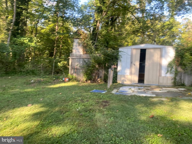 view of outbuilding with a yard