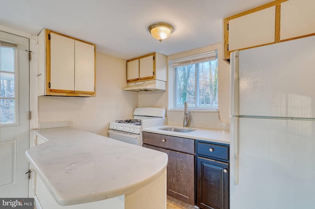 kitchen featuring white appliances and sink