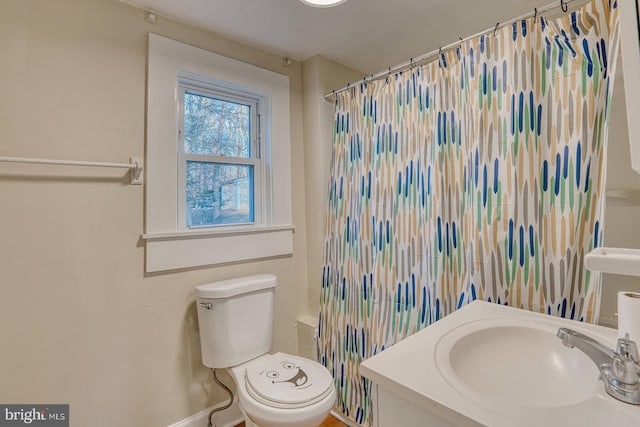 bathroom with toilet, sink, and walk in shower