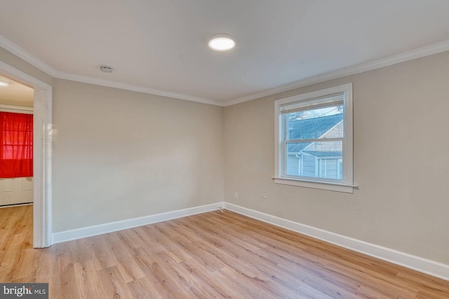 spare room with light wood-type flooring and ornamental molding