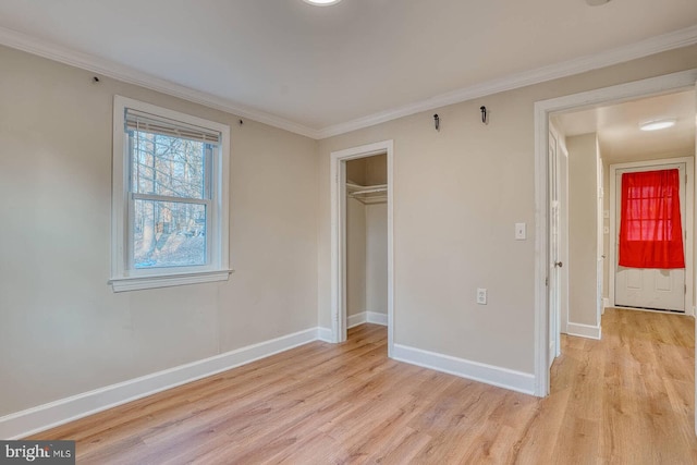 unfurnished bedroom featuring crown molding, a closet, and light hardwood / wood-style floors