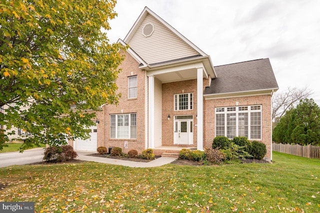 front of property featuring a front lawn and a garage