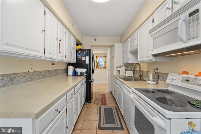 kitchen featuring white cabinetry, white appliances, sink, and light tile patterned flooring