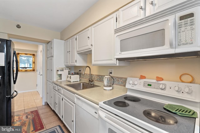 kitchen with white cabinetry, sink, white appliances, and light tile patterned flooring