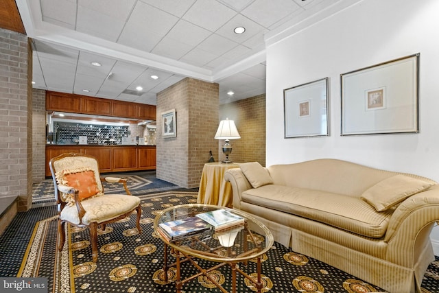 living room with carpet and brick wall