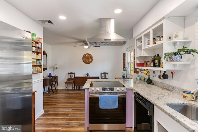 kitchen featuring white cabinetry, hardwood / wood-style flooring, appliances with stainless steel finishes, and island range hood