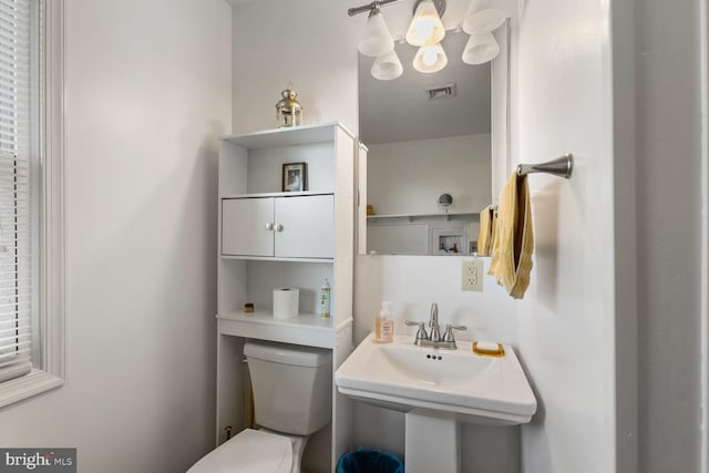 bathroom featuring toilet and sink