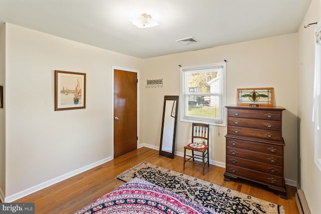 sitting room featuring hardwood / wood-style floors and a baseboard radiator