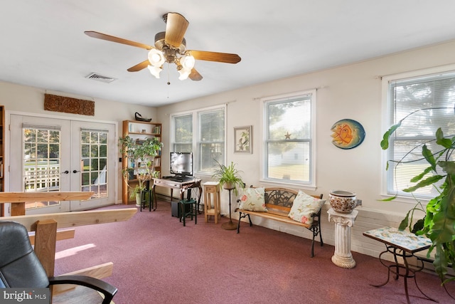 living area with french doors, carpet flooring, and ceiling fan