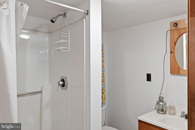 bathroom featuring vanity, curtained shower, and toilet