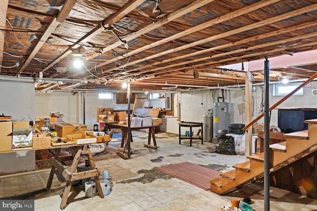 basement featuring electric panel and gas water heater