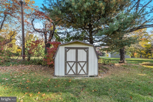 view of outbuilding featuring a lawn