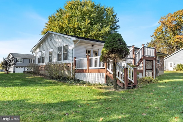 view of side of property with a yard, a wooden deck, and a garage