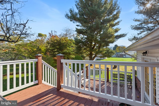 wooden deck with a lawn