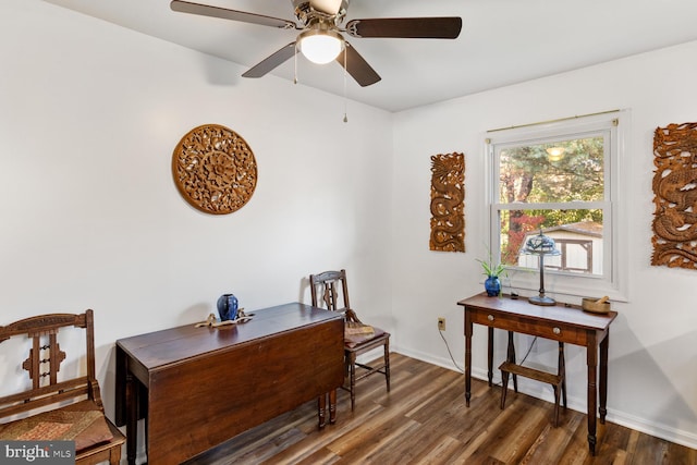 home office with dark wood-type flooring and ceiling fan