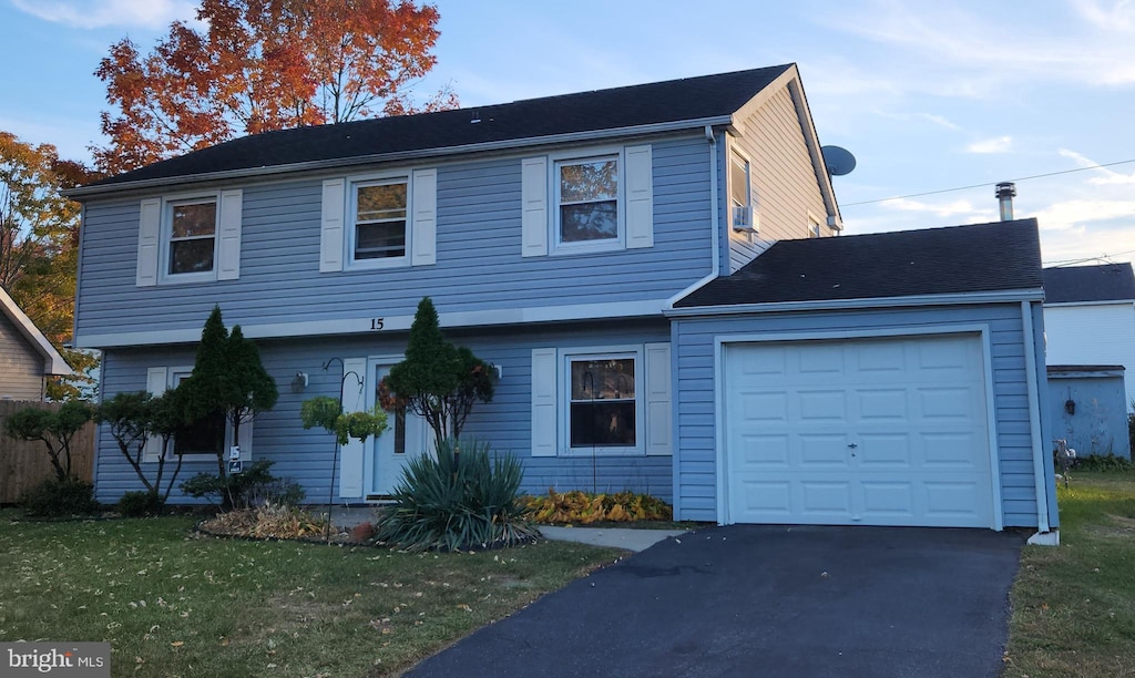 view of front of property featuring a garage and a front yard