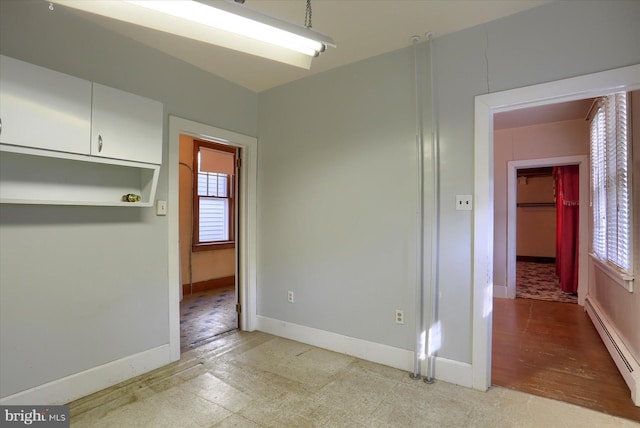 unfurnished room featuring baseboards and baseboard heating