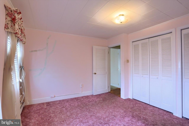 unfurnished bedroom featuring carpet floors and baseboards