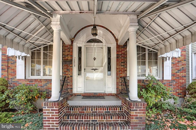 view of exterior entry with brick siding