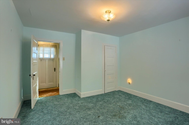 unfurnished bedroom with carpet floors and baseboards