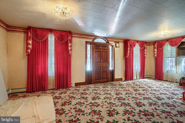 carpeted foyer with a baseboard heating unit, baseboards, and baseboard heating