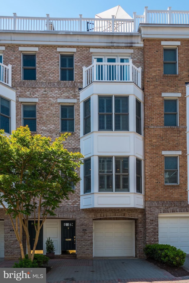 view of front of home with a balcony and a garage